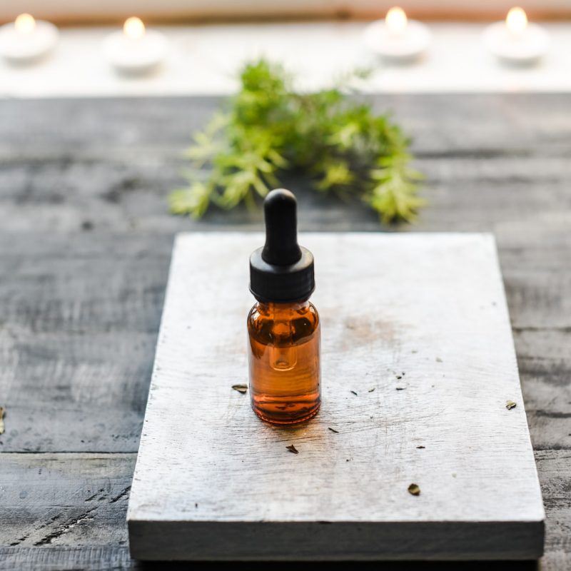 brown glass bottle on brown wooden table