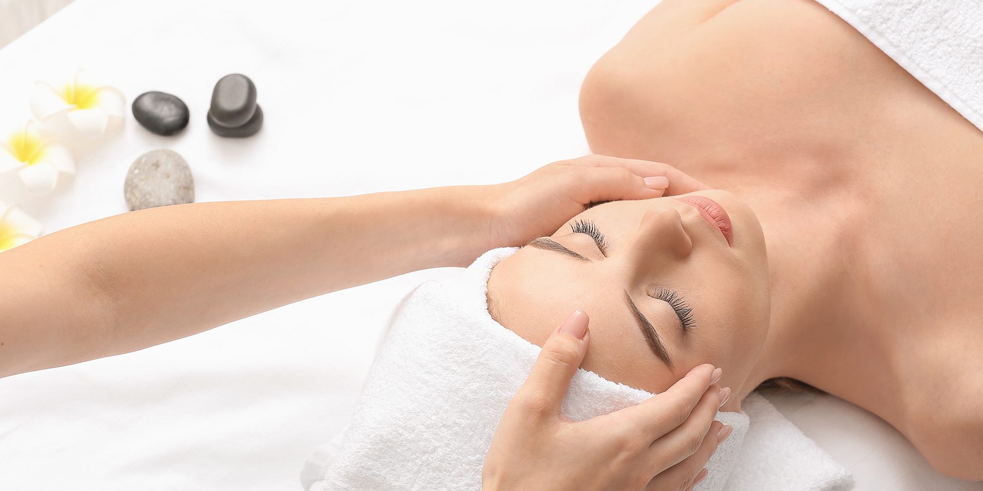 Young woman having facial massage in beauty salon